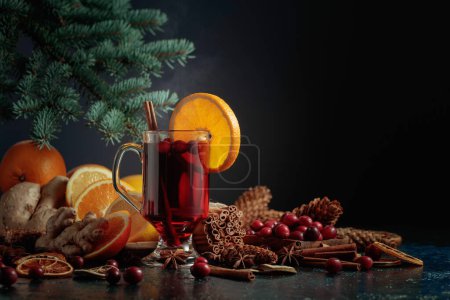 Photo for Hot Christmas drink with spices, ginger, cranberries, and citrus. - Royalty Free Image