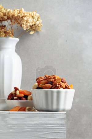 Photo for Dried fruits and nuts on a white wooden table. Copy space. - Royalty Free Image