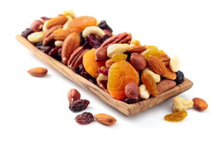 Photo for Mix of nuts and dried fruits isolated on a white background. Presented apricots, raisins, walnuts, hazelnuts, cashews, pecans, and almonds. - Royalty Free Image