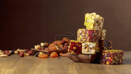 Foto de Traditional Turkish delight, nuts, and dried fruits on a wooden table. Copy space. - Imagen libre de derechos