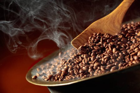Photo for Medium-roasted coffee beans are smoky in a roasting pan. Copy space. - Royalty Free Image