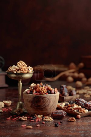 Photo for Various dried fruits and nuts on a kitchen table. Copy space. - Royalty Free Image