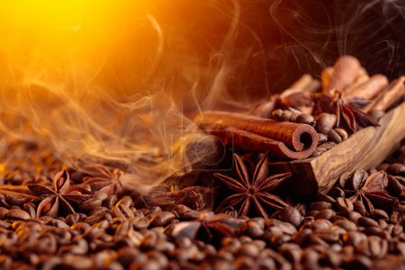 Téléchargez les photos : Roasted coffee beans with cinnamon sticks, anise, and nutmeg. Steaming coffee beans with spices in a wooden dish. - en image libre de droit