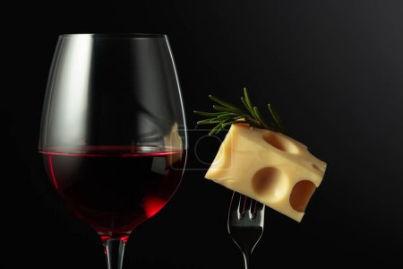 Photo for Glass of red wine and Maasdam cheese with rosemary on a black background. - Royalty Free Image