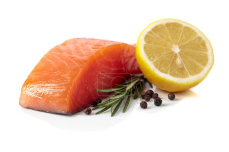 Photo for Raw salmon piece with rosemary, lemon, and peppercorn isolated on a white background. - Royalty Free Image