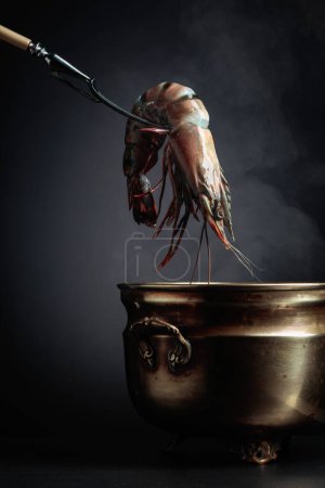 Photo for Fresh tiger prawns are placed in an old pot of hot water. - Royalty Free Image