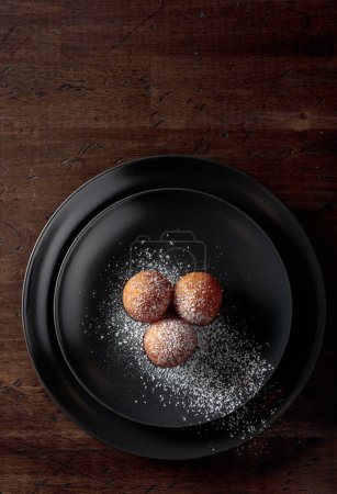 Photo for Balls of freshly baked homemade cottage cheese doughnuts sprinkled with sugar powder. Top view. Copy space. - Royalty Free Image