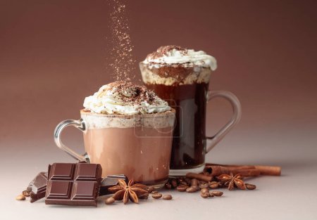 Photo for Hot chocolate and coffee with whipped cream sprinkled with chocolate crumbs. Hot holiday drinks with ingredients. - Royalty Free Image