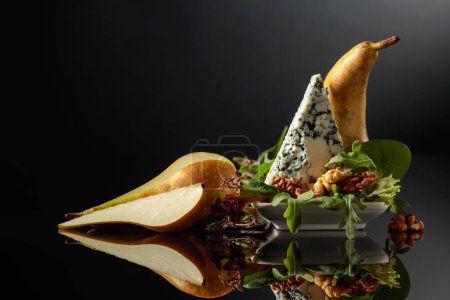 Photo for Blue cheese with walnuts and  pear on a black background. - Royalty Free Image