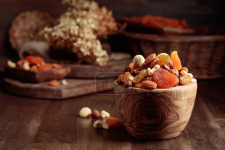 Photo for Dried fruits and assorted nuts on an old wooden table. - Royalty Free Image