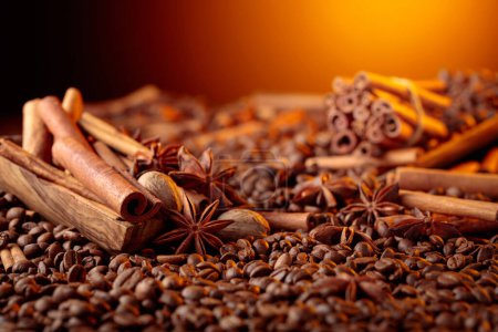 Foto de Roasted coffee beans with cinnamon sticks, anise, and nutmeg. Selective focus. Copy space. - Imagen libre de derechos