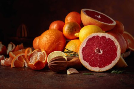 Photo for Citrus fruits on a old brown table. Presented are oranges, grapefruits, lemons, and tangerines. - Royalty Free Image