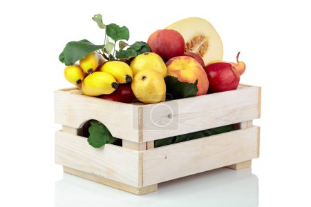 Photo for Fresh fruits in a wooden box isolated on a white background. Apples, bananas, melon, pears, and peaches are presented. - Royalty Free Image