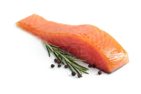 Foto de Raw salmon piece with rosemary and peppercorn isolated on a white background. - Imagen libre de derechos