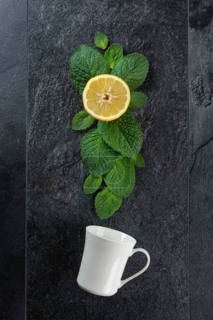 Photo for White mug, lemon, and mint leaves, top view. - Royalty Free Image