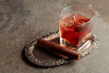 Photo for Whiskey with ice and cigar on a silver tray. Copy space. - Royalty Free Image