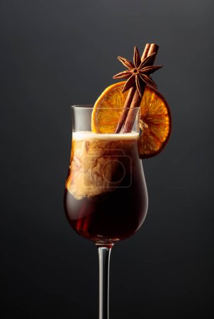 Foto de White Russian cocktail garnished with cinnamon, anise, and dried orange slice. - Imagen libre de derechos