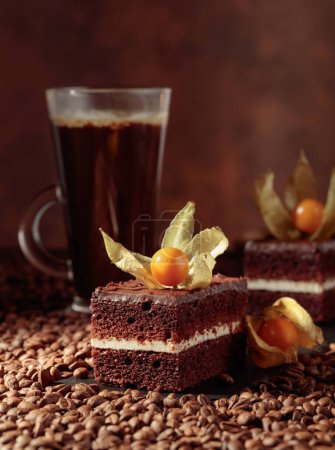 Photo for Chocolate cake garnished with physalis on a table with coffee beans. - Royalty Free Image