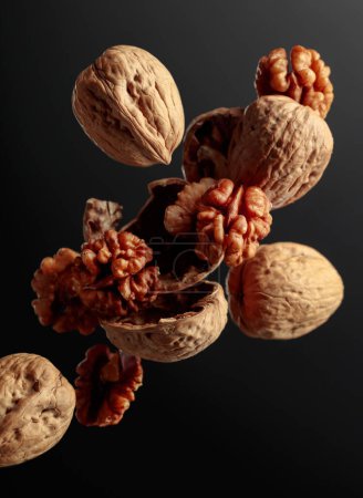 Photo for Food levitation. Walnuts on a black background. - Royalty Free Image