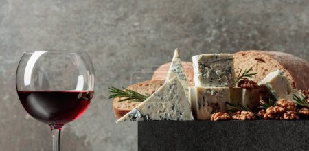 Photo for Blue cheese and red wine. Cheese with walnuts, bread, and rosemary. Copy space. - Royalty Free Image