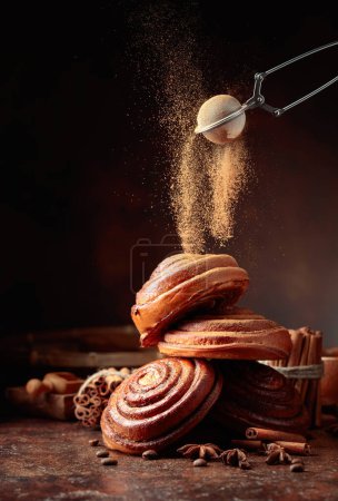 Photo for Sweet buns sprinkled with cinnamon powder. Copy space. - Royalty Free Image