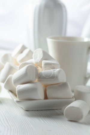 Photo for White marshmallows on a white wooden table. - Royalty Free Image