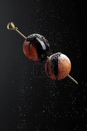 Photo for Homemade cottage cheese doughnuts with chocolate sauce and sprinkled with sugar powder. - Royalty Free Image