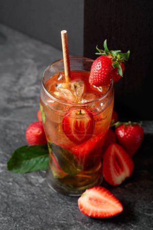 Photo for Iced tea or a summer refreshing drink with ice, mint, and strawberries. - Royalty Free Image