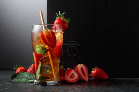 Photo for Iced tea or a summer refreshing drink with ice, mint, and strawberries. Copy space. - Royalty Free Image