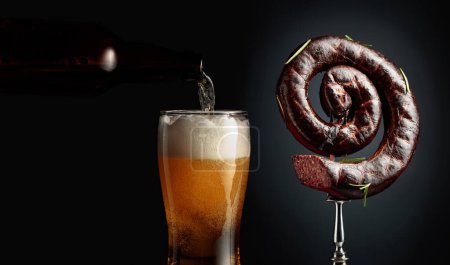 Photo for Spanish black pudding or blood sausage with rosemary and a glass of beer. Copy space. - Royalty Free Image