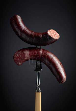 Photo for Black pudding or blood sausage on a black background.. - Royalty Free Image