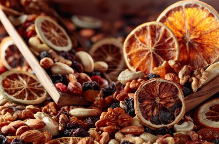 Photo for Dried fruits and nuts. Presented raisins, walnuts, almonds, goji berries, hazelnuts, cashews, and orange slices. Selective focus. - Royalty Free Image