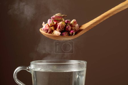 Photo for Dried rosebuds for making herbal tea and mug with hot water. - Royalty Free Image