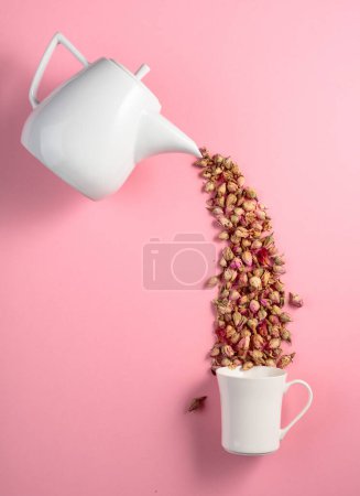 Photo for Dried rosebuds on a pink background. Concept image of the theme of herbal medicine. Top view with copy space. - Royalty Free Image
