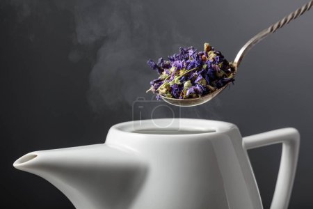 Photo for Dried mallow flowers are poured into the teapot. Selective focus. - Royalty Free Image