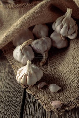 Foto de Garlic bulbs on an old wooden table. - Imagen libre de derechos