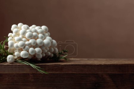 Photo for Shimeji mushrooms with rosemary on an old wooden table. Japanese cuisine. Copy space. - Royalty Free Image
