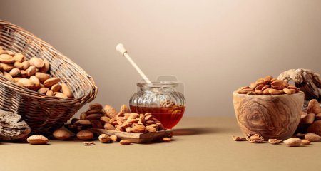 Foto de Nueces de almendra en platos de madera y miel en un frasco de vidrio. Copiar espacio. - Imagen libre de derechos