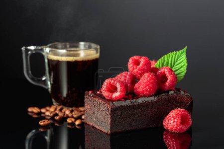 Photo for Chocolate cake with fresh raspberries and black coffee on a black reflective background. - Royalty Free Image