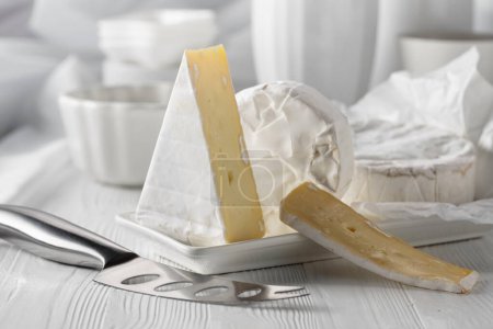 Photo for Camembert cheese on a white wooden table. - Royalty Free Image