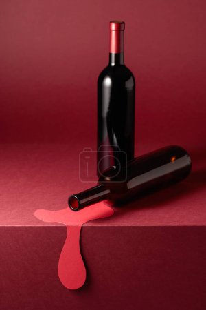 Photo for Bottles of red wine on a red background. Concept of the theme of red wine. Copy space. - Royalty Free Image