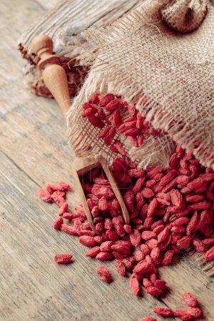 Photo for Dried goji berries on an old wooden table. - Royalty Free Image