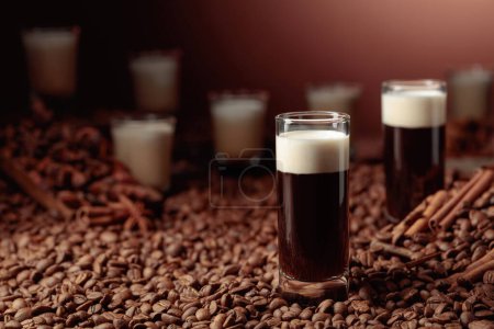 Photo for White Russian cocktail. Vodka, coffee liqueur, and cream. Coffee beans, cinnamon, and anise are scattered on the table. - Royalty Free Image