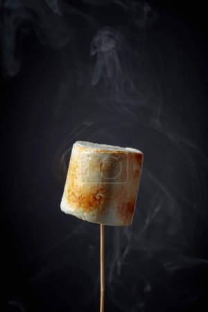 Photo for Toasted marshmallows with smoke on a black background. - Royalty Free Image