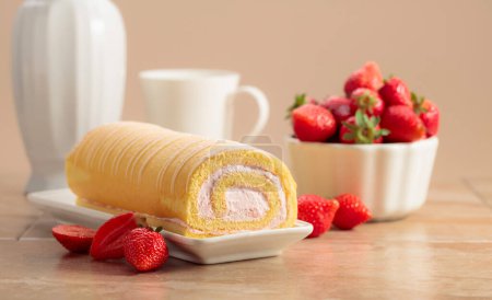 Photo for Homemade strawberry biscuit cake roll with cream cheese, whipped cream, and fresh berries. Delicious biscuit cake with strawberries on a beige background. - Royalty Free Image