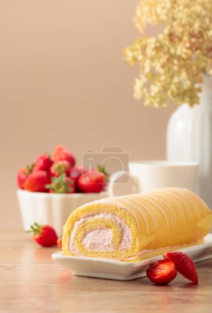 Photo for Homemade strawberry biscuit cake roll with cream cheese, whipped cream, and fresh berries. Delicious biscuit cake with strawberries on a beige background. - Royalty Free Image