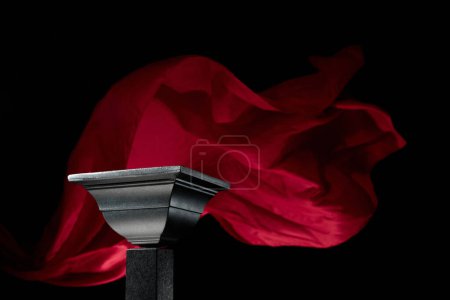 Photo for Luxury black podium on a background of waving red atlas curtain. Perfect platform for showing your products on a dark background. - Royalty Free Image
