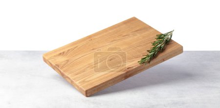 Photo for Cutting board falling on a grey stone table. Isolated on a white background. Culinary background. Empty wooden cutting board, product display space. - Royalty Free Image