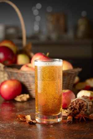 Photo for Apple cider with fresh apples, cinnamon, and anise on a kitchen table. - Royalty Free Image