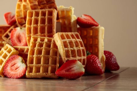 Photo for Belgian waffles with strawberries on a beige ceramic table. - Royalty Free Image